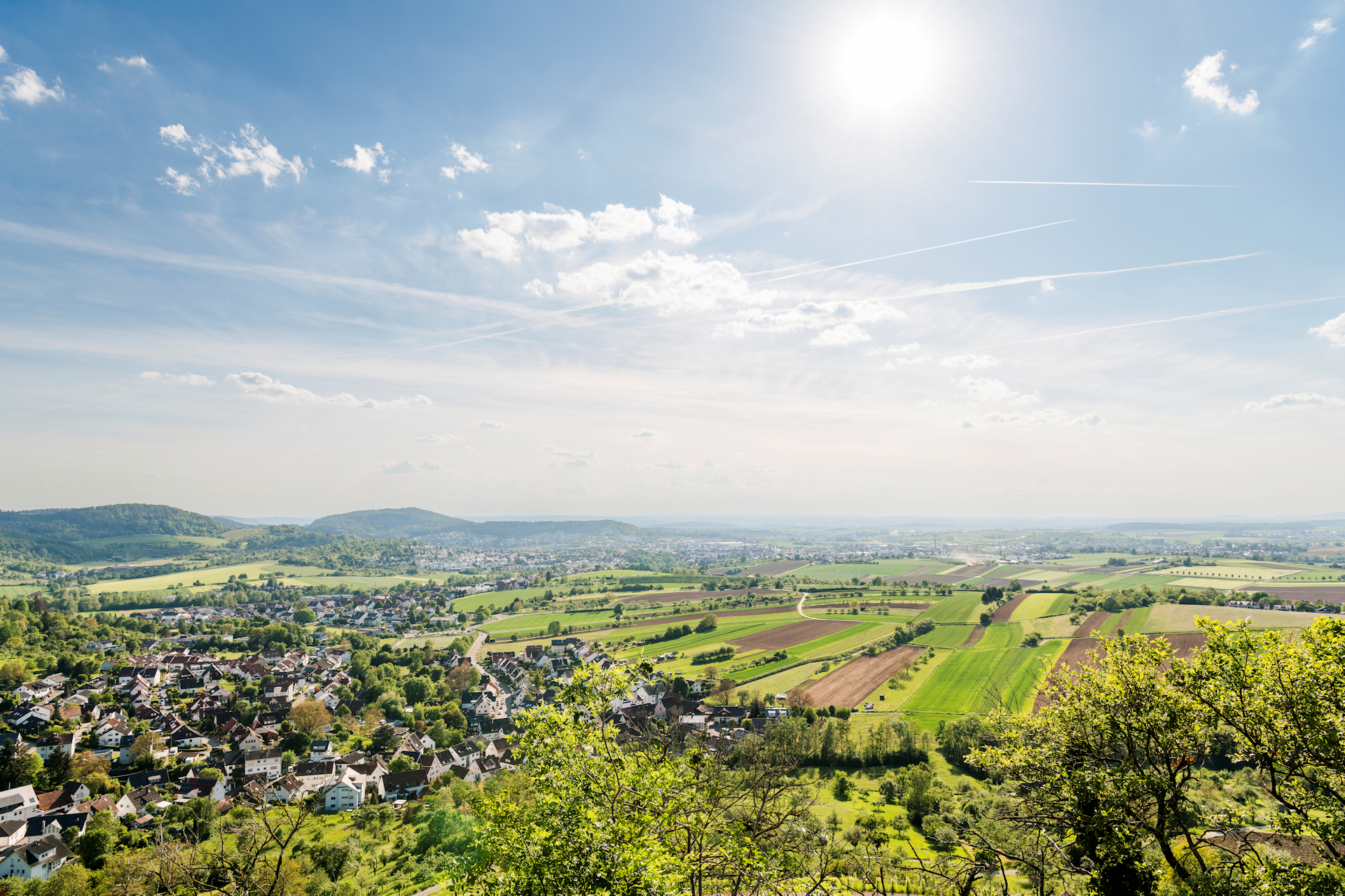 Ausblick aus Winnenden von Bürg. Bei strahlend blauem Himmel leuchten die grünen Wiesen um Winnenden.
