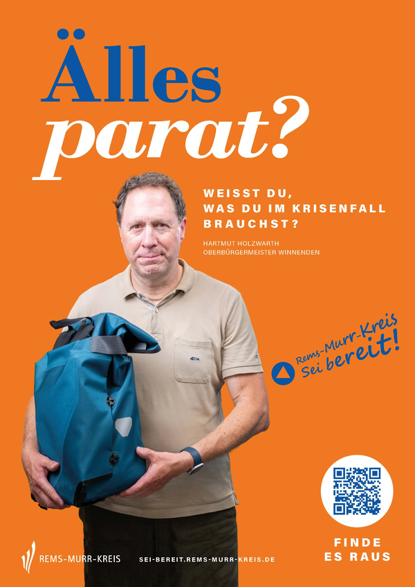 Plakat: Oberbürgermeister Hartmut Holzwarth hält einen Rucksack im Arm. Darüber steht die Überschrift: "Älles parat?"