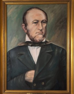 Das Ehrenbürgergemälde zeigt Dr. Christian Wunderlich im Anzug mit ernster Miene